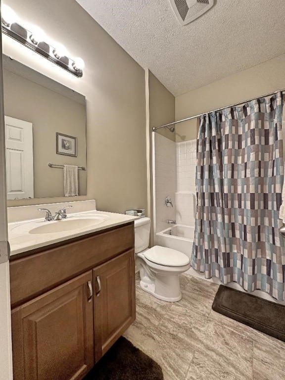 full bathroom with a textured ceiling, shower / bath combo, vanity, and toilet