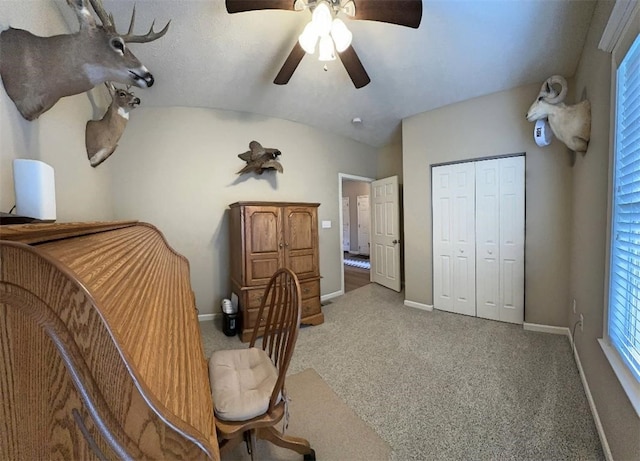 sitting room with vaulted ceiling, ceiling fan, and carpet flooring