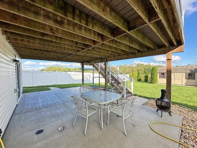 view of patio featuring a storage unit