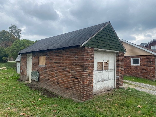 view of outbuilding featuring a yard