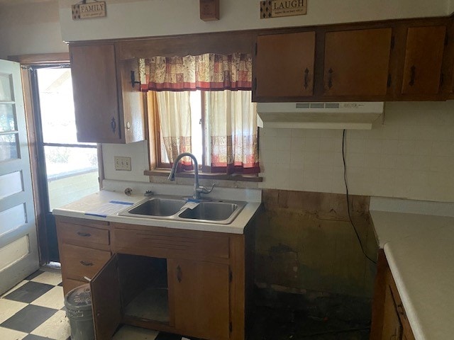 kitchen featuring decorative backsplash, sink, and a wealth of natural light