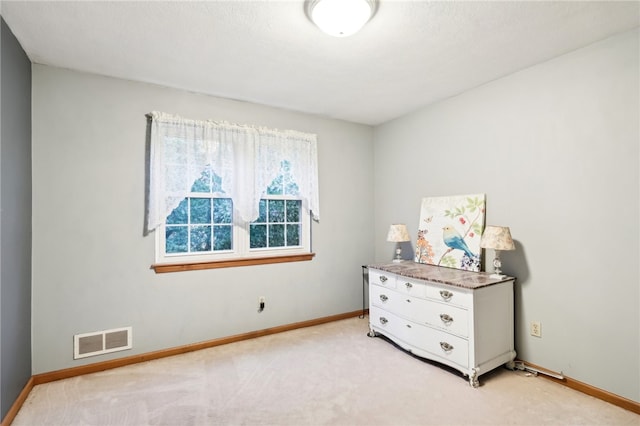 unfurnished bedroom with light colored carpet