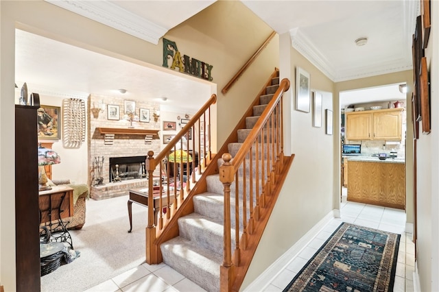 stairs featuring a fireplace, crown molding, and tile patterned flooring