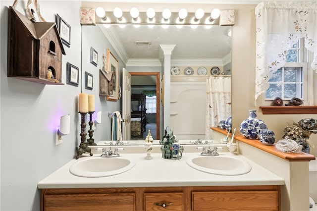 bathroom with ornamental molding and vanity