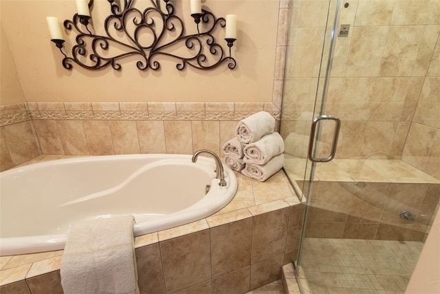 bathroom featuring shower with separate bathtub