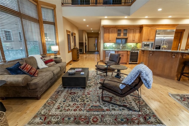 living room featuring light wood-type flooring and beverage cooler