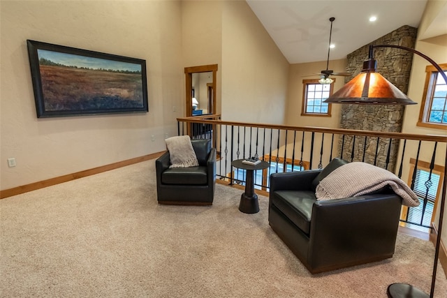 sitting room featuring ceiling fan, light colored carpet, and high vaulted ceiling