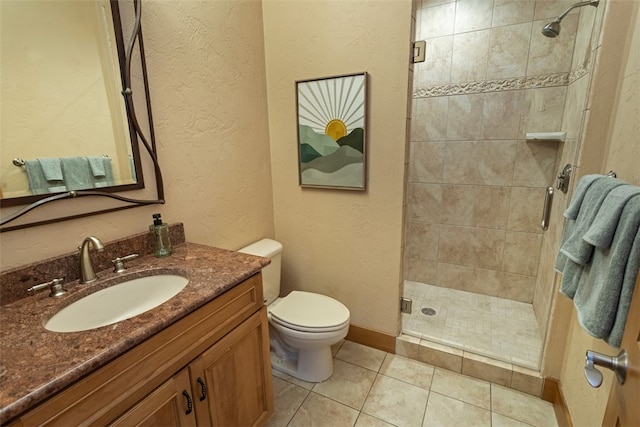 bathroom with tile patterned floors, vanity, an enclosed shower, and toilet