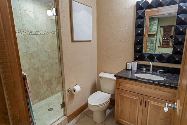 bathroom with toilet, vanity, tile patterned floors, and walk in shower