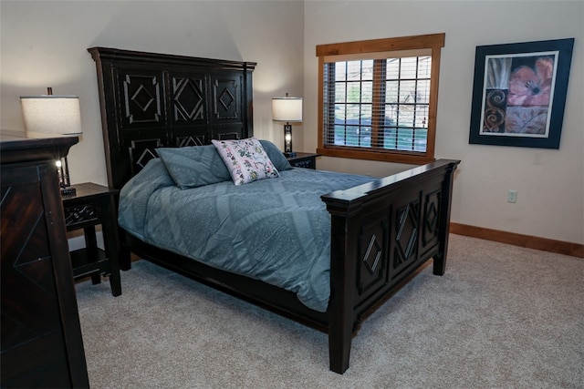 bedroom featuring light carpet