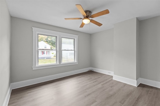 unfurnished room with ceiling fan and hardwood / wood-style floors