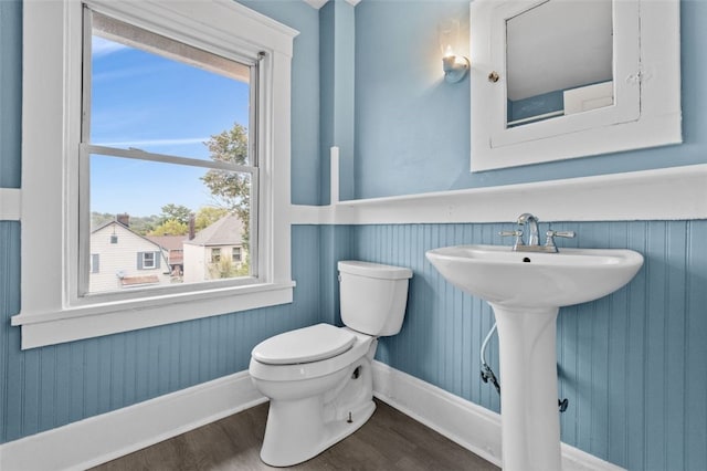 bathroom with hardwood / wood-style flooring, sink, toilet, and a wealth of natural light