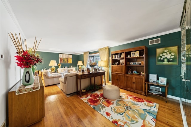 living room featuring crown molding and light hardwood / wood-style floors