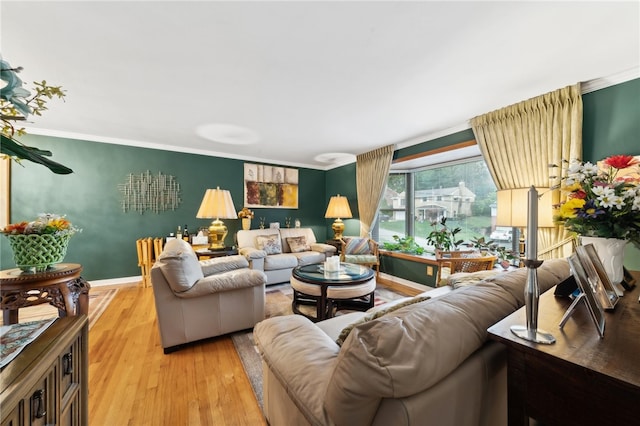 living room featuring light wood-type flooring and ornamental molding