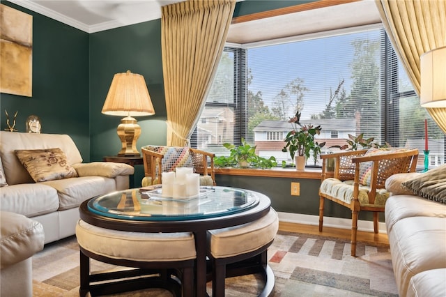 sitting room featuring wood-type flooring and ornamental molding