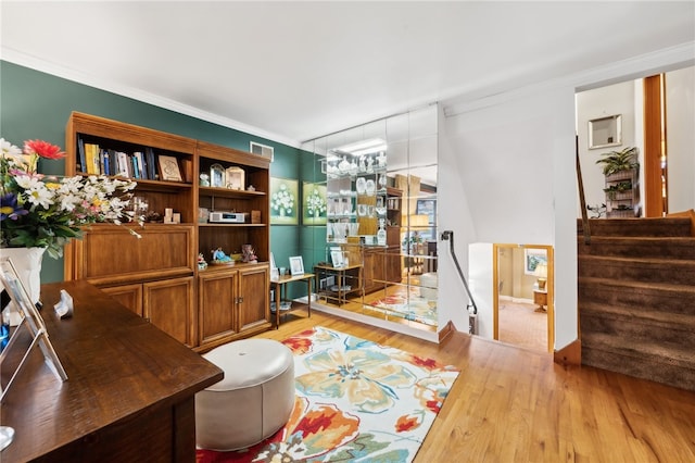 office space with light wood-type flooring and crown molding