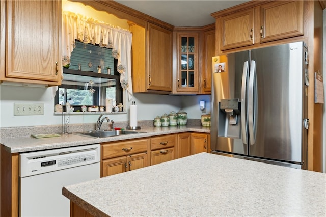 kitchen with white dishwasher, sink, and stainless steel fridge with ice dispenser