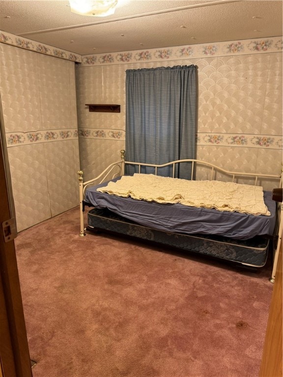 unfurnished bedroom with a textured ceiling and carpet flooring