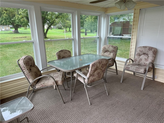 sunroom / solarium with ceiling fan and a healthy amount of sunlight