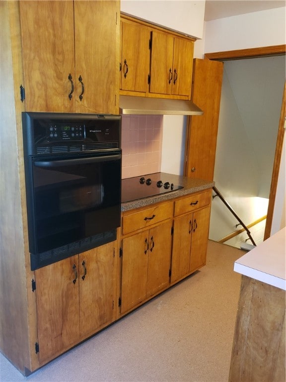 kitchen with black appliances and tasteful backsplash