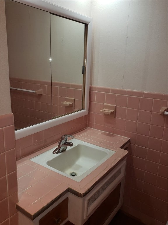 bathroom with tile walls and vanity