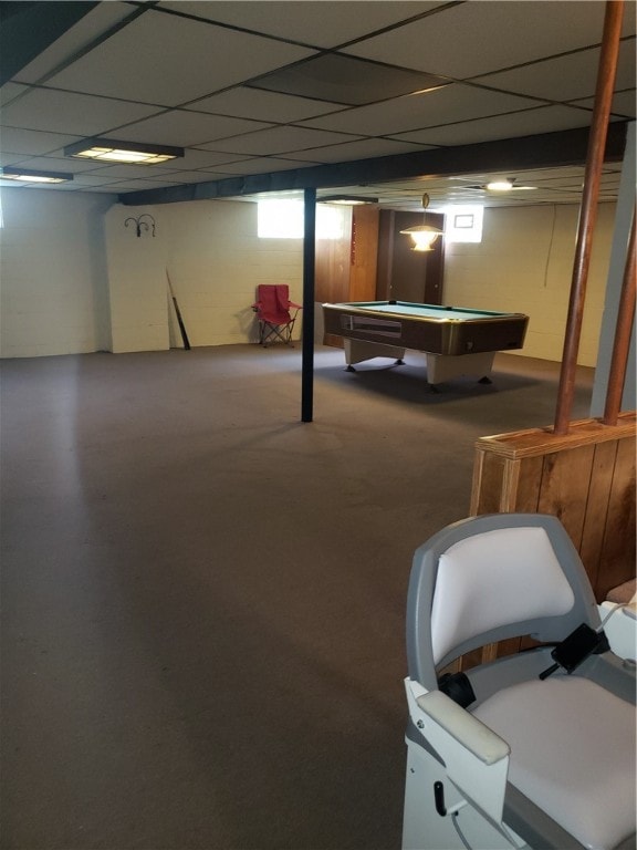 basement featuring a paneled ceiling and pool table