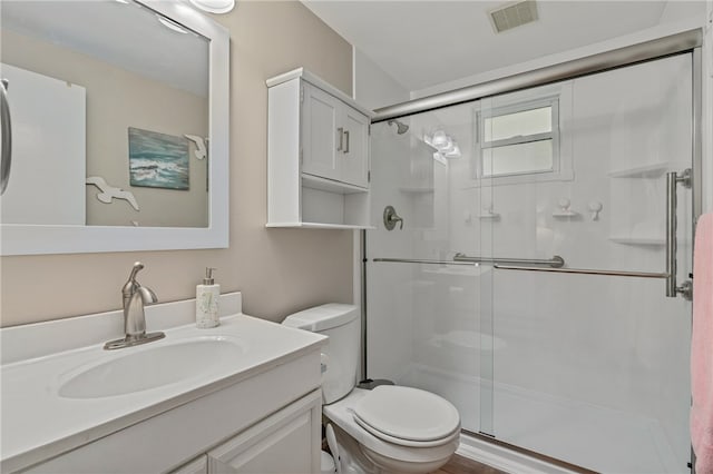 bathroom with walk in shower, vanity, and toilet