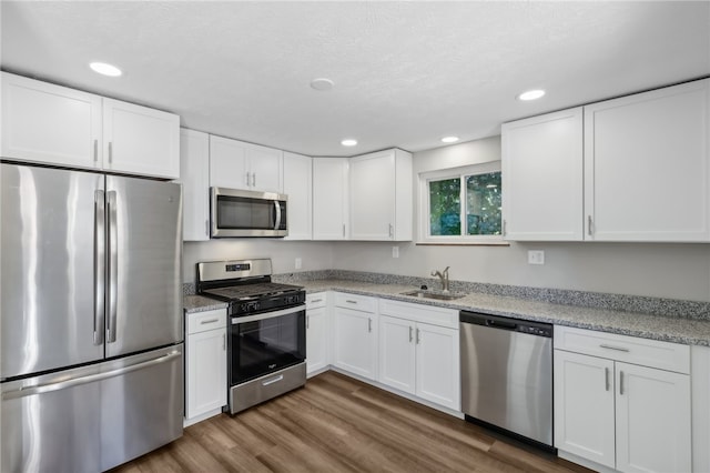 kitchen with stainless steel appliances and white cabinetry