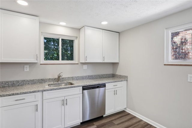 kitchen featuring dishwasher, white cabinetry, dark wood-type flooring, and sink