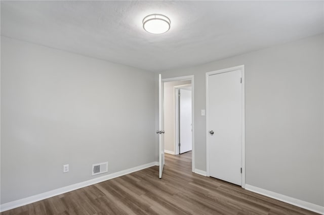 empty room with hardwood / wood-style flooring