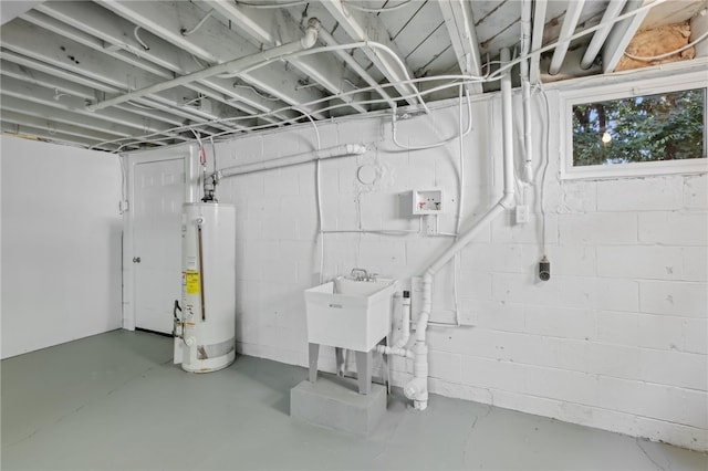 basement featuring water heater and sink