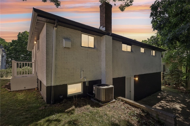 property exterior at dusk featuring central AC