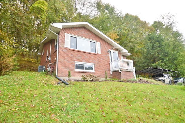 view of property exterior featuring a lawn, cooling unit, and a carport