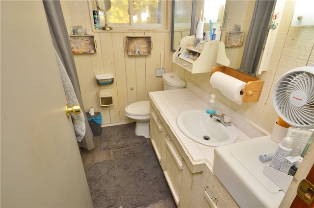 bathroom with vanity, toilet, and hardwood / wood-style flooring