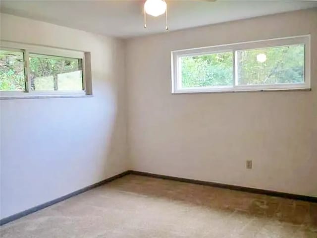 spare room featuring ceiling fan and light colored carpet