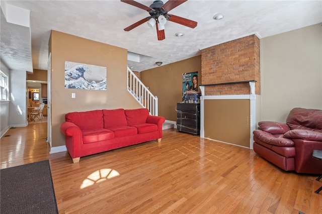 living room with wood-type flooring and ceiling fan