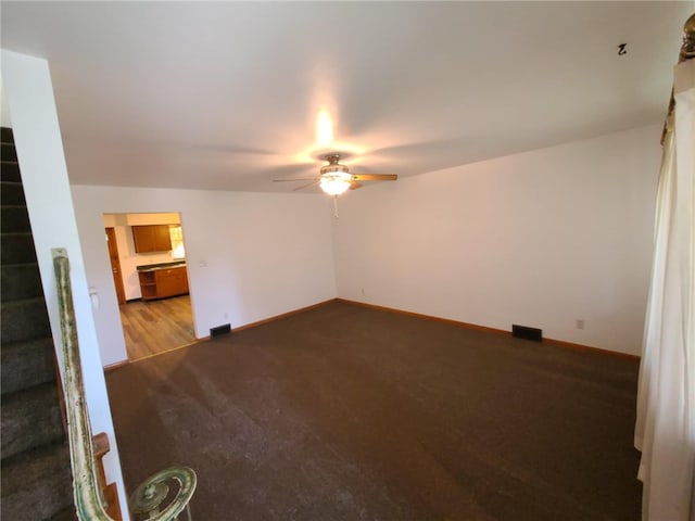 unfurnished living room with ceiling fan and carpet flooring