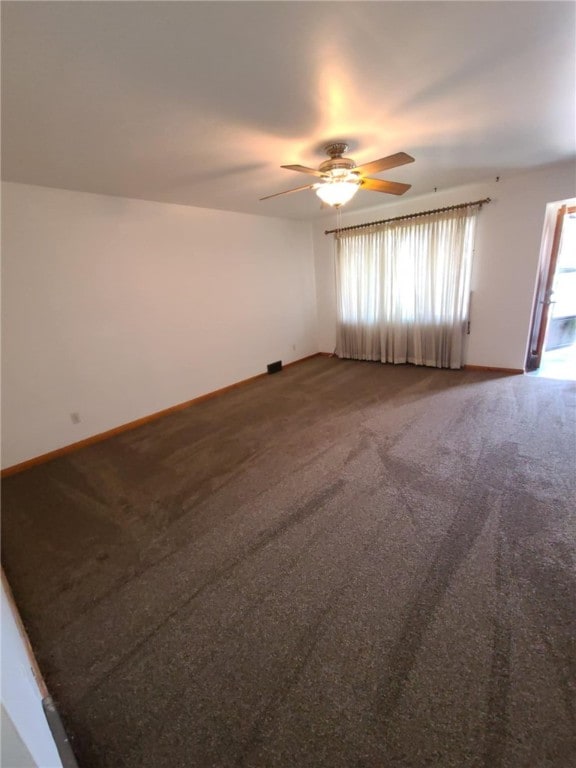 spare room with carpet and ceiling fan