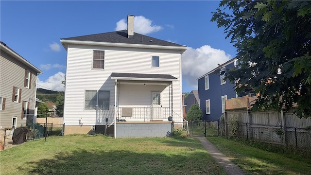 back of property featuring central air condition unit and a lawn