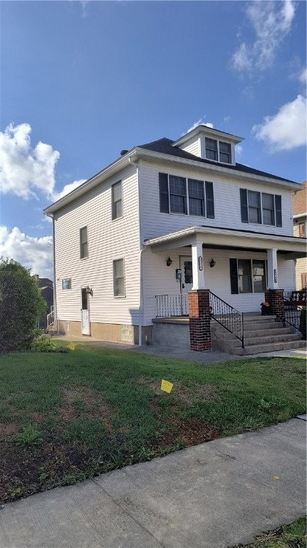 view of front of home with covered porch and a front lawn