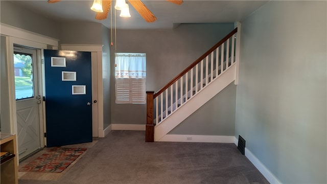 carpeted entrance foyer with ceiling fan