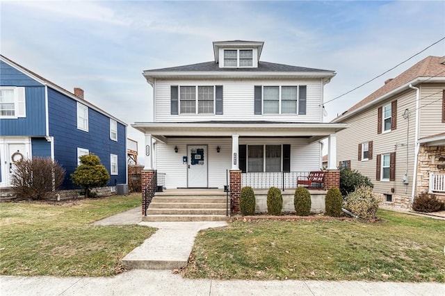 view of front of home featuring a front yard and covered porch