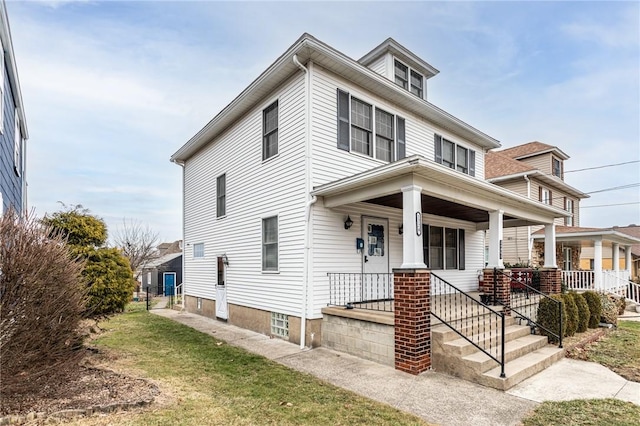 view of front of home with covered porch and a front yard