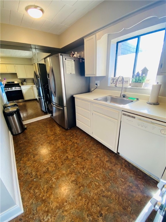 kitchen featuring sink, appliances with stainless steel finishes, and white cabinetry