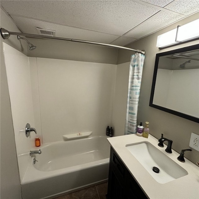 bathroom featuring vanity, shower / bath combo, a paneled ceiling, and tile patterned flooring