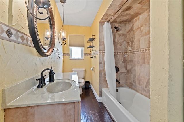 full bathroom with vanity, shower / bath combo with shower curtain, toilet, and hardwood / wood-style flooring