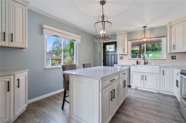 kitchen featuring decorative light fixtures, plenty of natural light, hardwood / wood-style floors, and a kitchen island