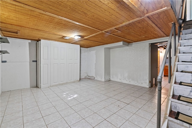 basement featuring wood ceiling and light tile patterned floors