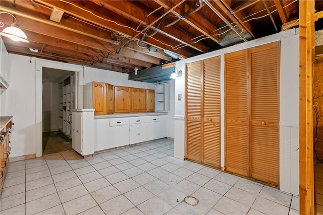 basement featuring light tile patterned flooring