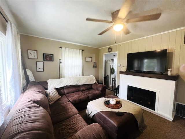 living room with carpet flooring, ceiling fan, and crown molding